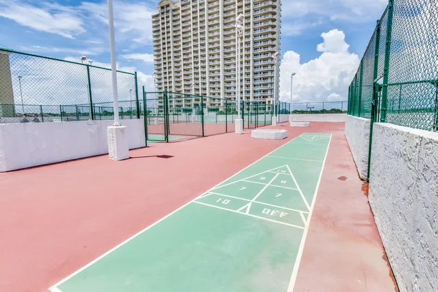 a spacious bedroom with a bed and a chandelier