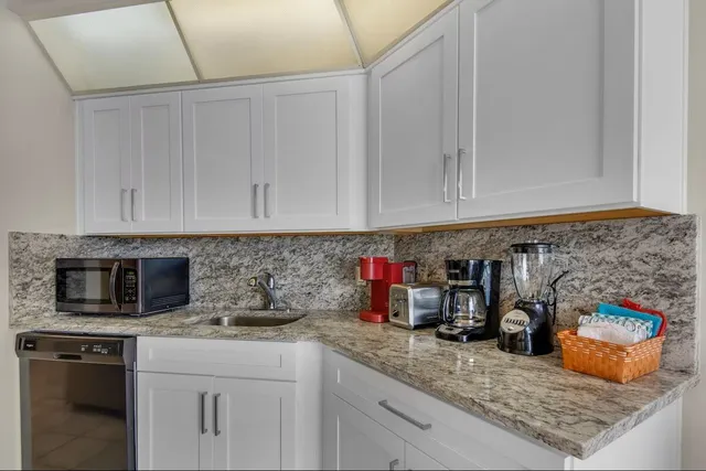 a large kitchen with a table and chairs
