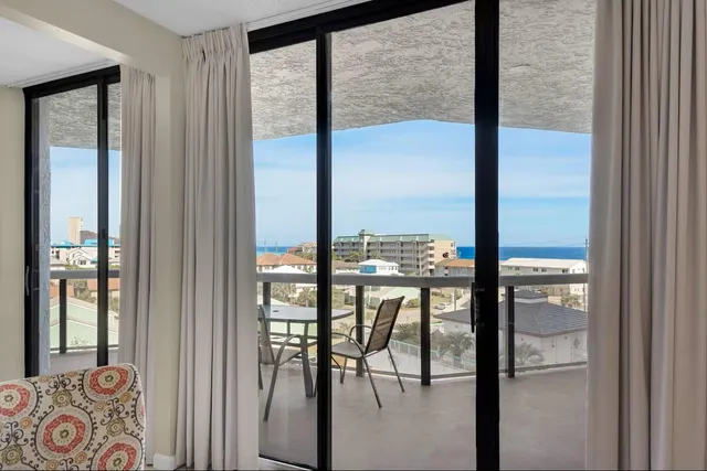 a view of a room with balcony and furniture