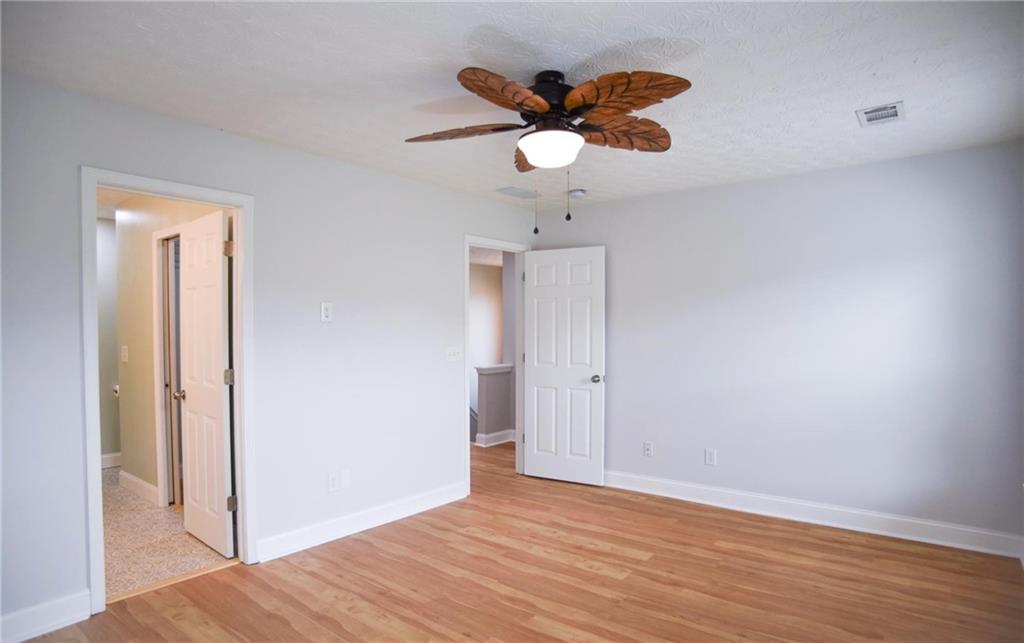 6616 Splashwater Drive Flowery Branch, GA 30542 - Photo 13 of 33 a view of empty room with wooden floor