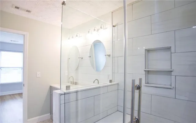 a bathroom with a double vanity sink mirror and double