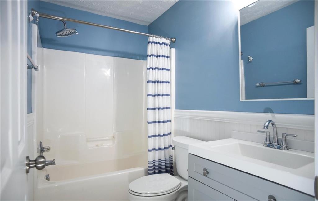 6616 Splashwater Drive Flowery Branch, GA 30542 - Photo 20 of 33 a bathroom with a sink toilet and shower