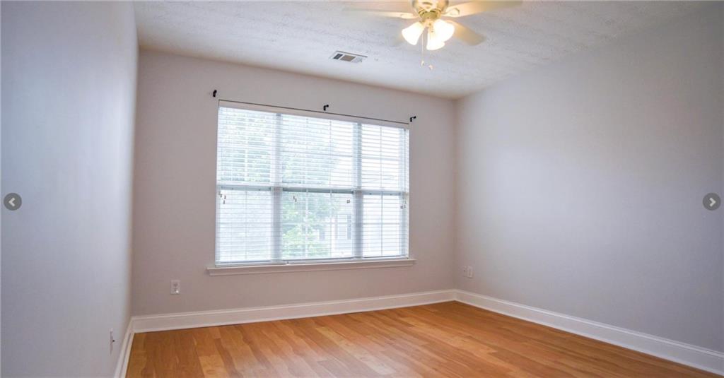 6616 Splashwater Drive Flowery Branch, GA 30542 - Photo 21 of 33 wooden floor in an empty room with a window