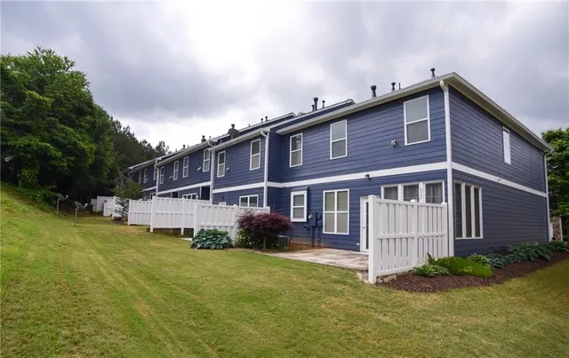 a view of house with outdoor space and swimming pool