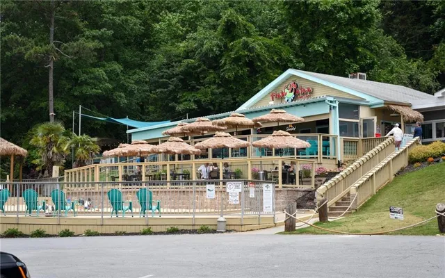 a view of swimming pool with outdoor seating and lake
