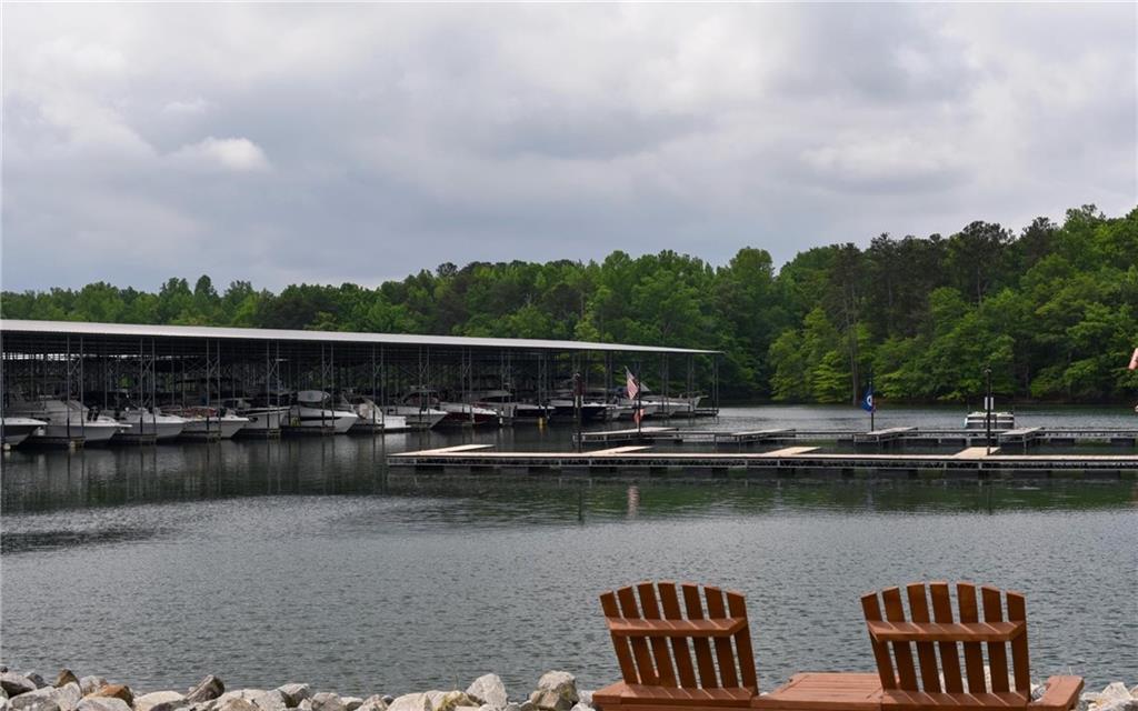 6616 Splashwater Drive Flowery Branch, GA 30542 - Photo 25 of 33 a view of swimming pool with outdoor seating and lake