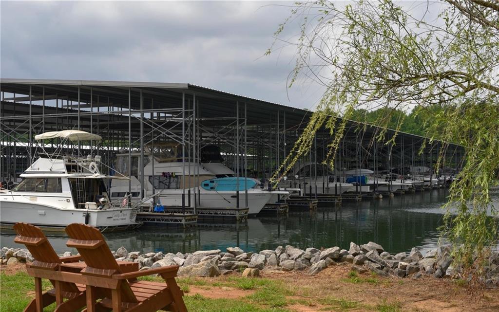 6616 Splashwater Drive Flowery Branch, GA 30542 - Photo 29 of 33 a view of a lake with boats and large trees