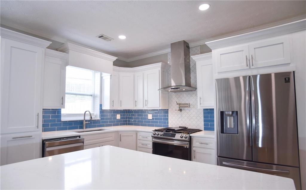 6616 Splashwater Drive Flowery Branch, GA 30542 - Photo 3 of 33 a kitchen with granite countertop a refrigerator stove and sink