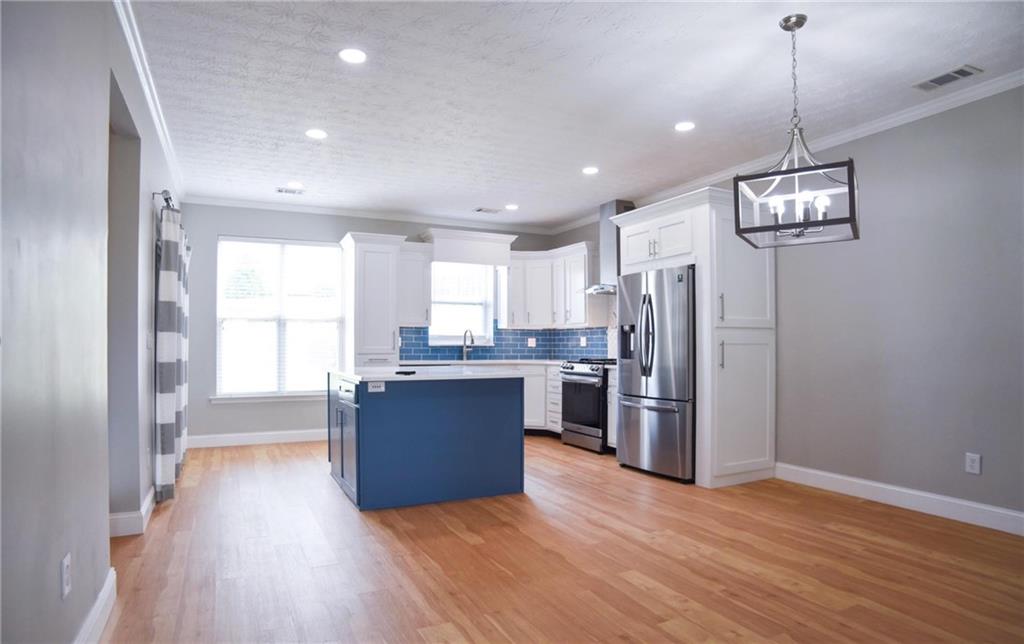 6616 Splashwater Drive Flowery Branch, GA 30542 - Photo 4 of 33 a view of kitchen with refrigerator microwave and stove top oven