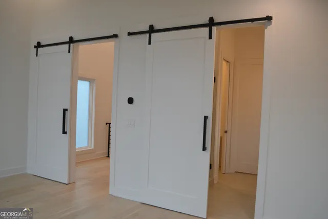 a bathroom with a shower and a glass door