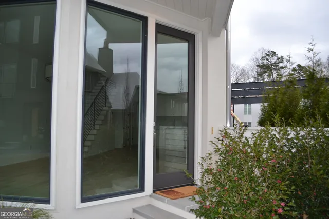 a bathroom with a glass door and shower