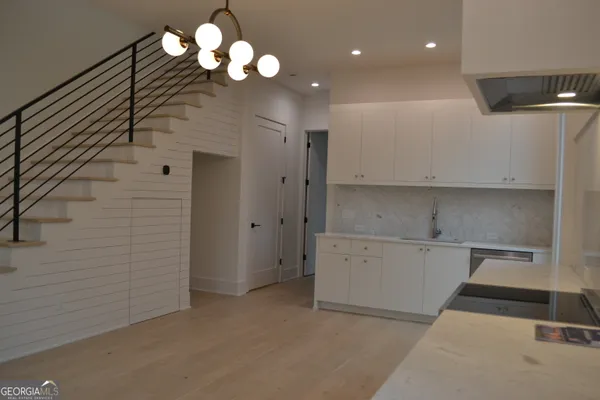 a view of a hallway with chandelier
