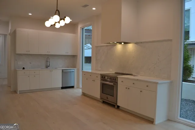 a view of a kitchen with a sink and dishwasher