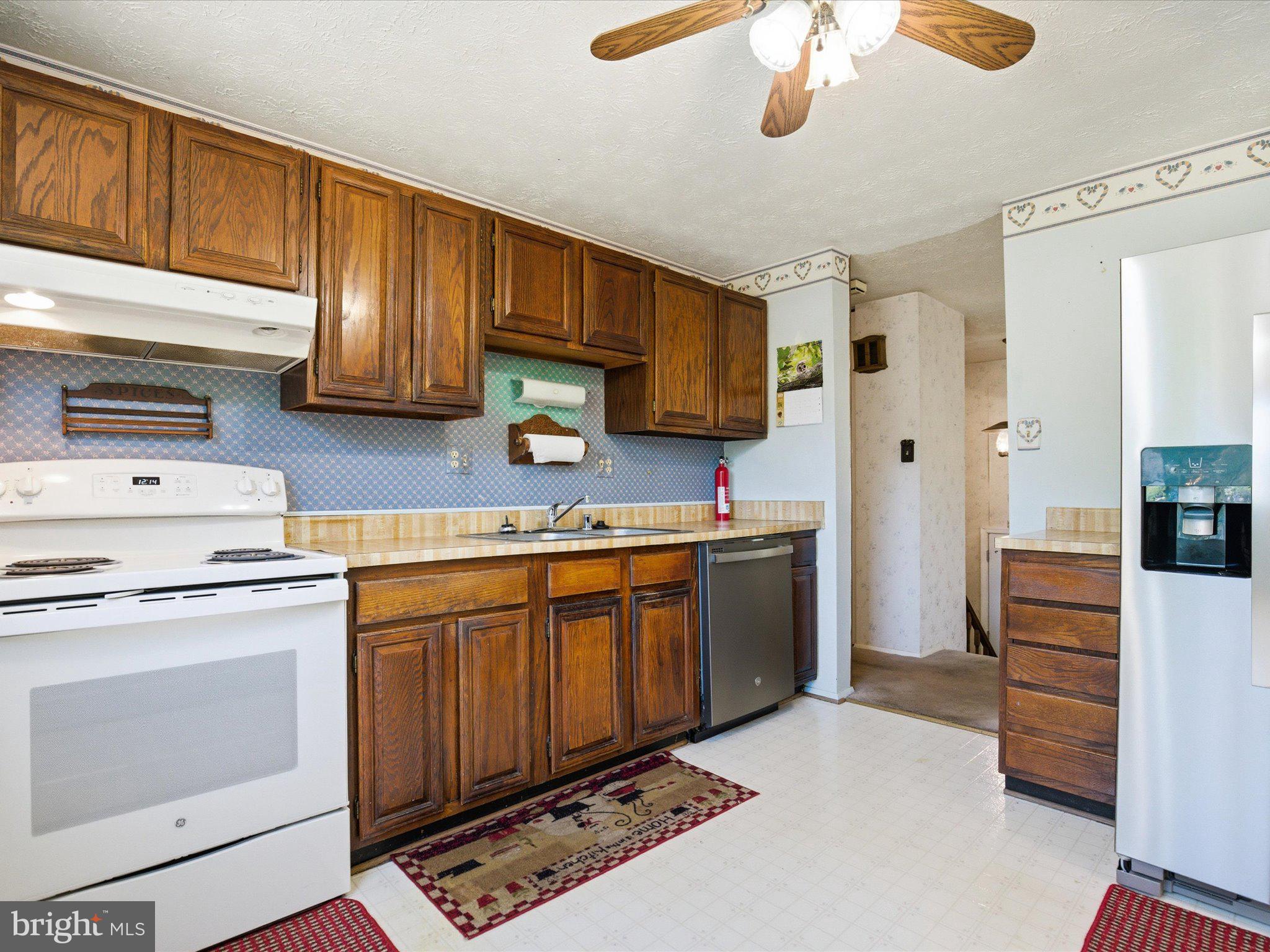 6314 West Vein Road Bowie, MD 20720 - Photo 14 of 28 a kitchen with stainless steel appliances a stove sink and cabinets