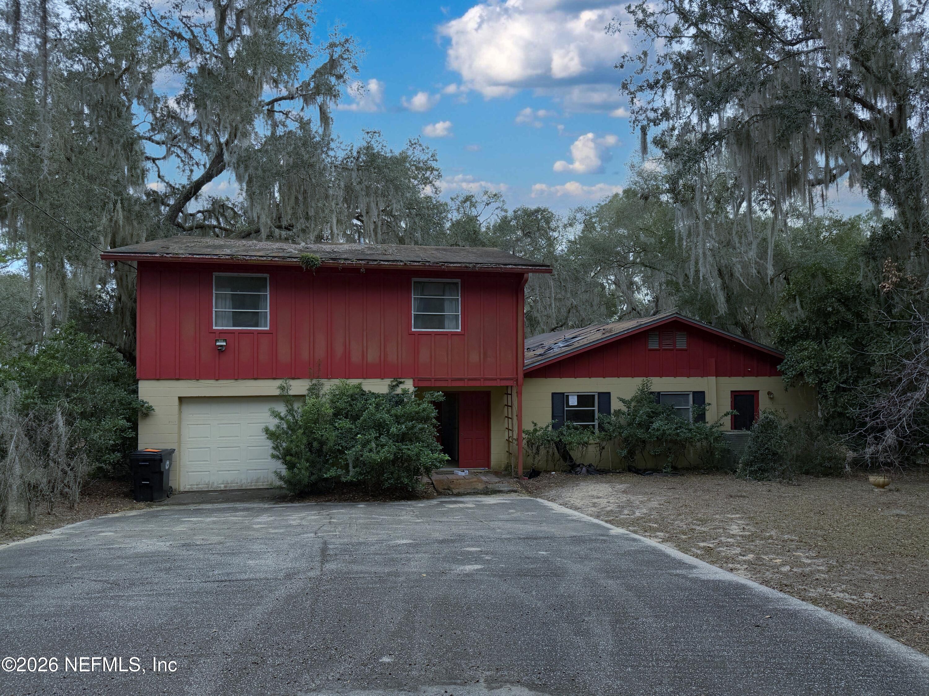 a front view of a house with yard and tress