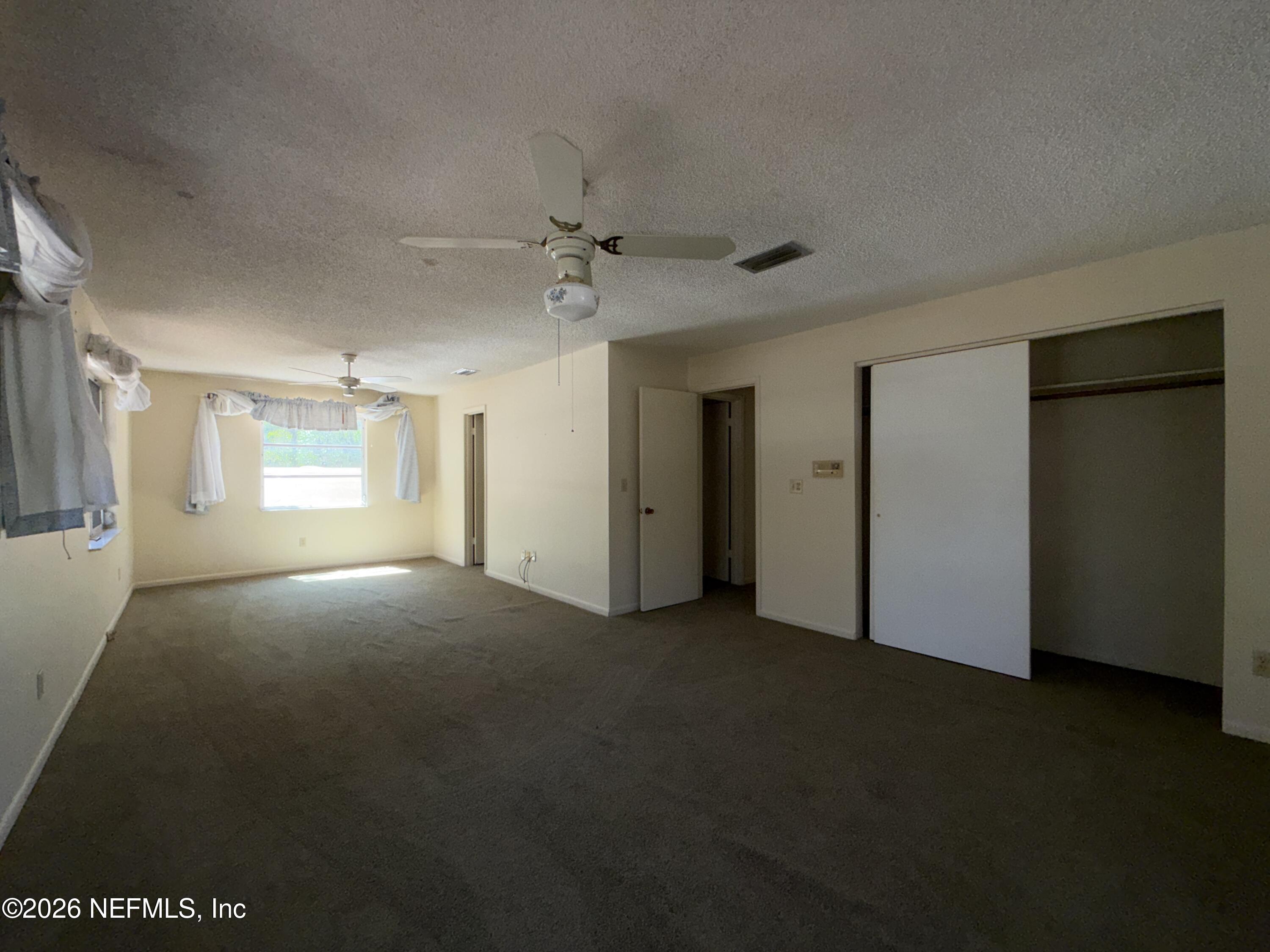 5943 White Sands Road Keystone Heights, FL 32656 - Photo 17 of 18 a view of empty room with windows