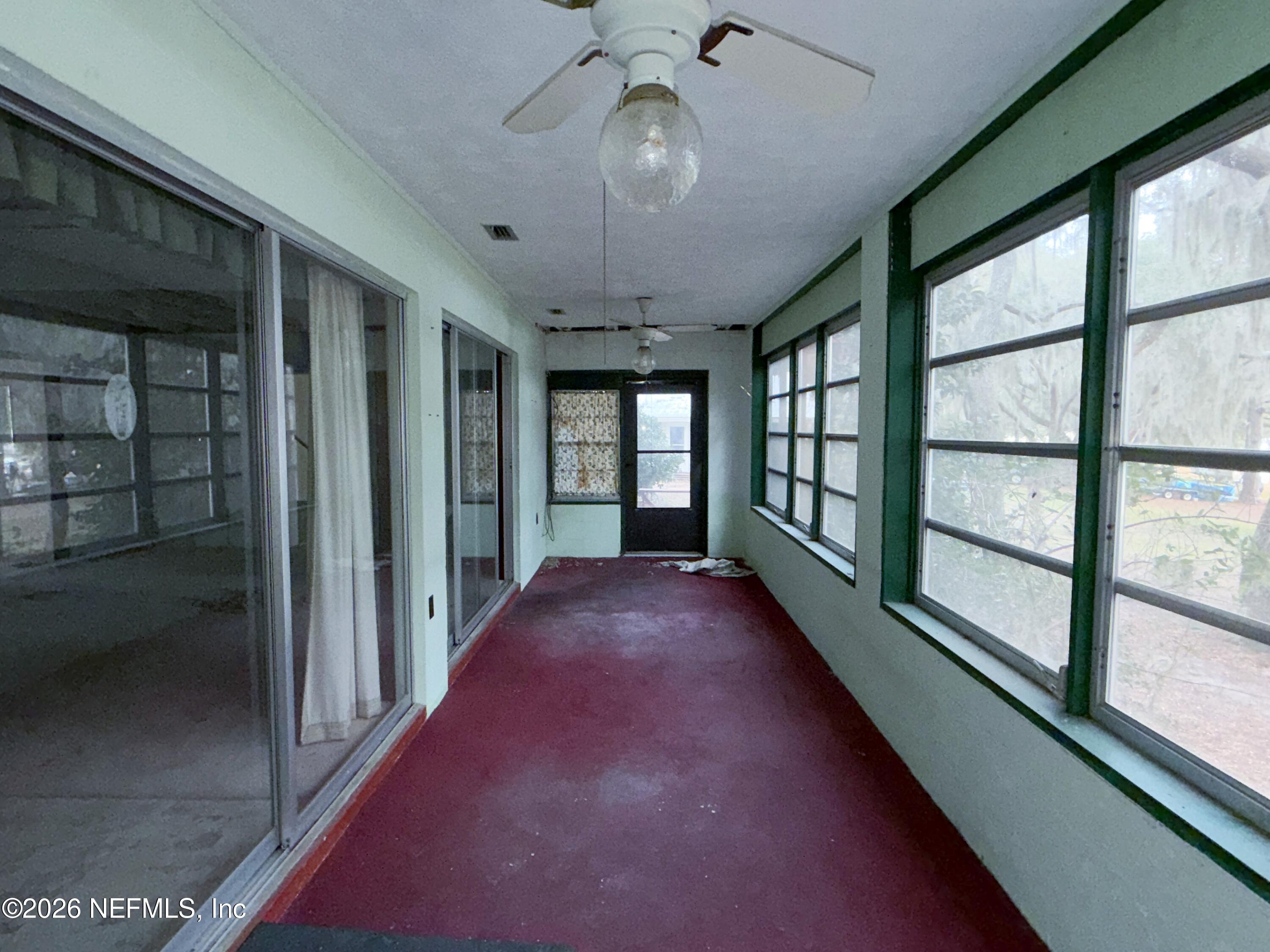 5943 White Sands Road Keystone Heights, FL 32656 - Photo 18 of 18 a view of a hallway with a chandelier