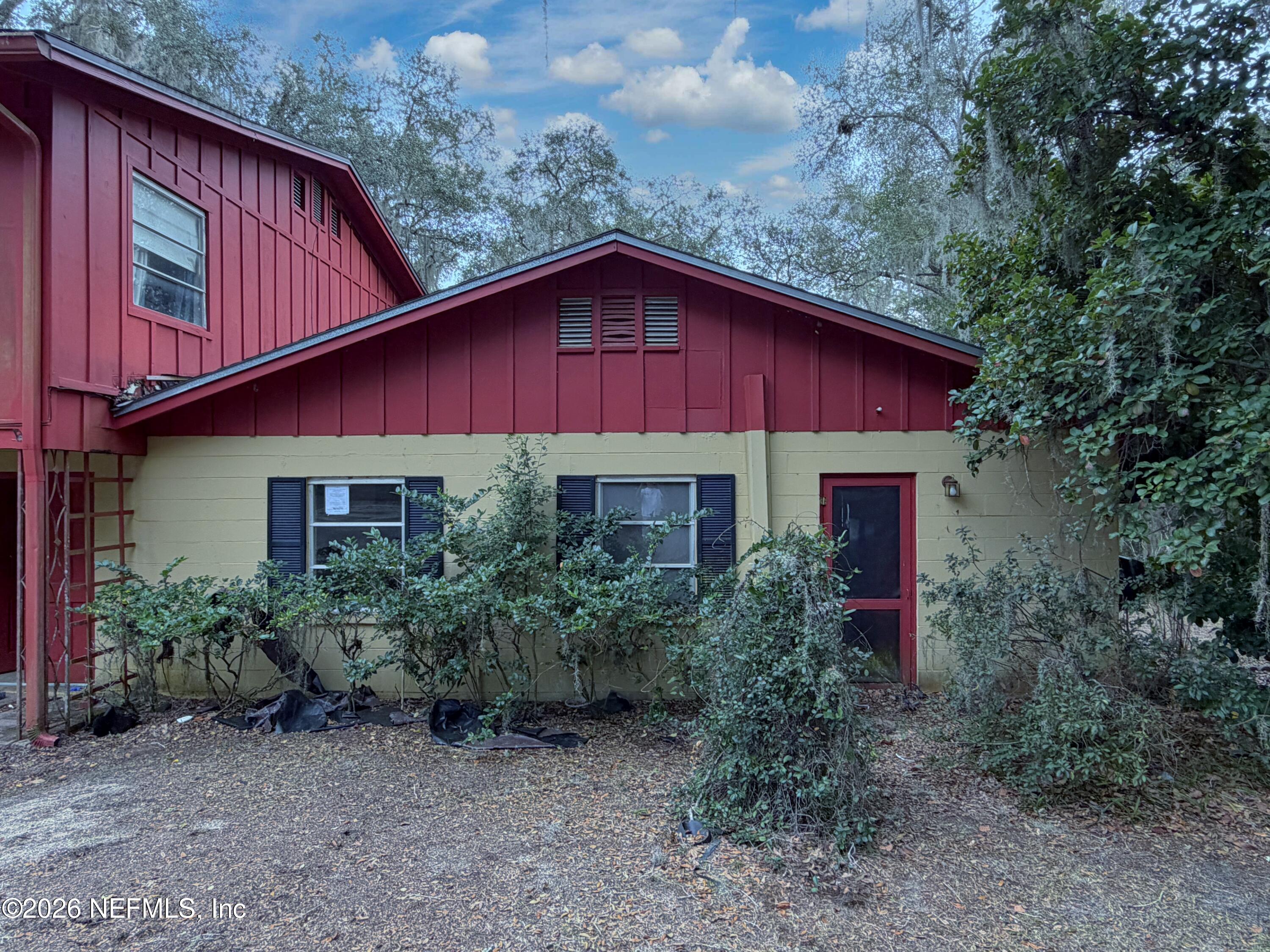 5943 White Sands Road Keystone Heights, FL 32656 - Photo 3 of 18 a view of a house with a yard plants and large tree