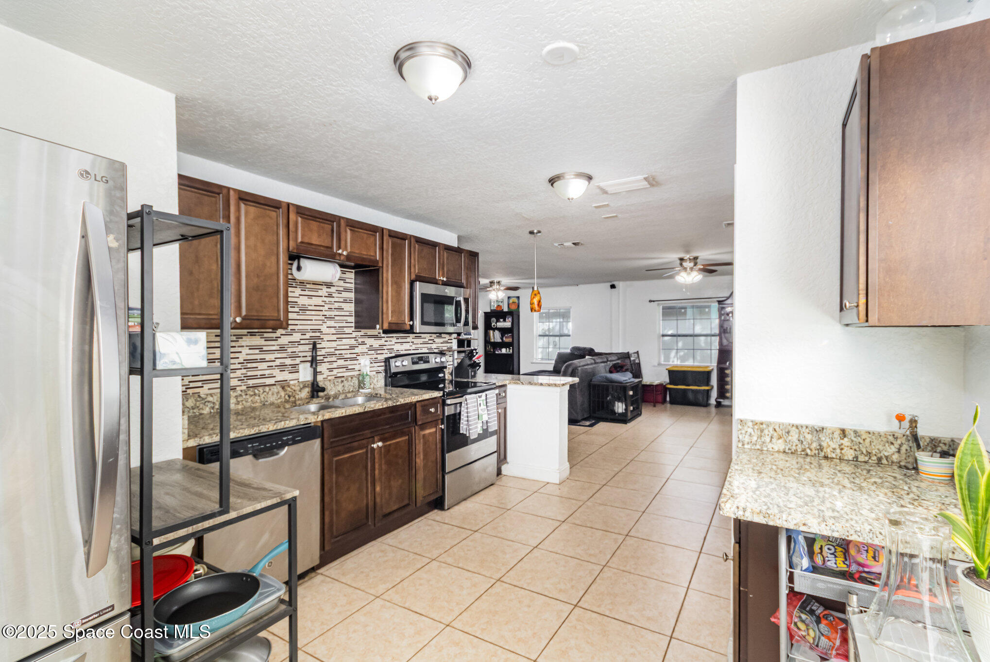 2004 High Street Leesburg, FL 34748 - Photo 12 of 30 a kitchen with stainless steel appliances granite countertop a refrigerator and a sink
