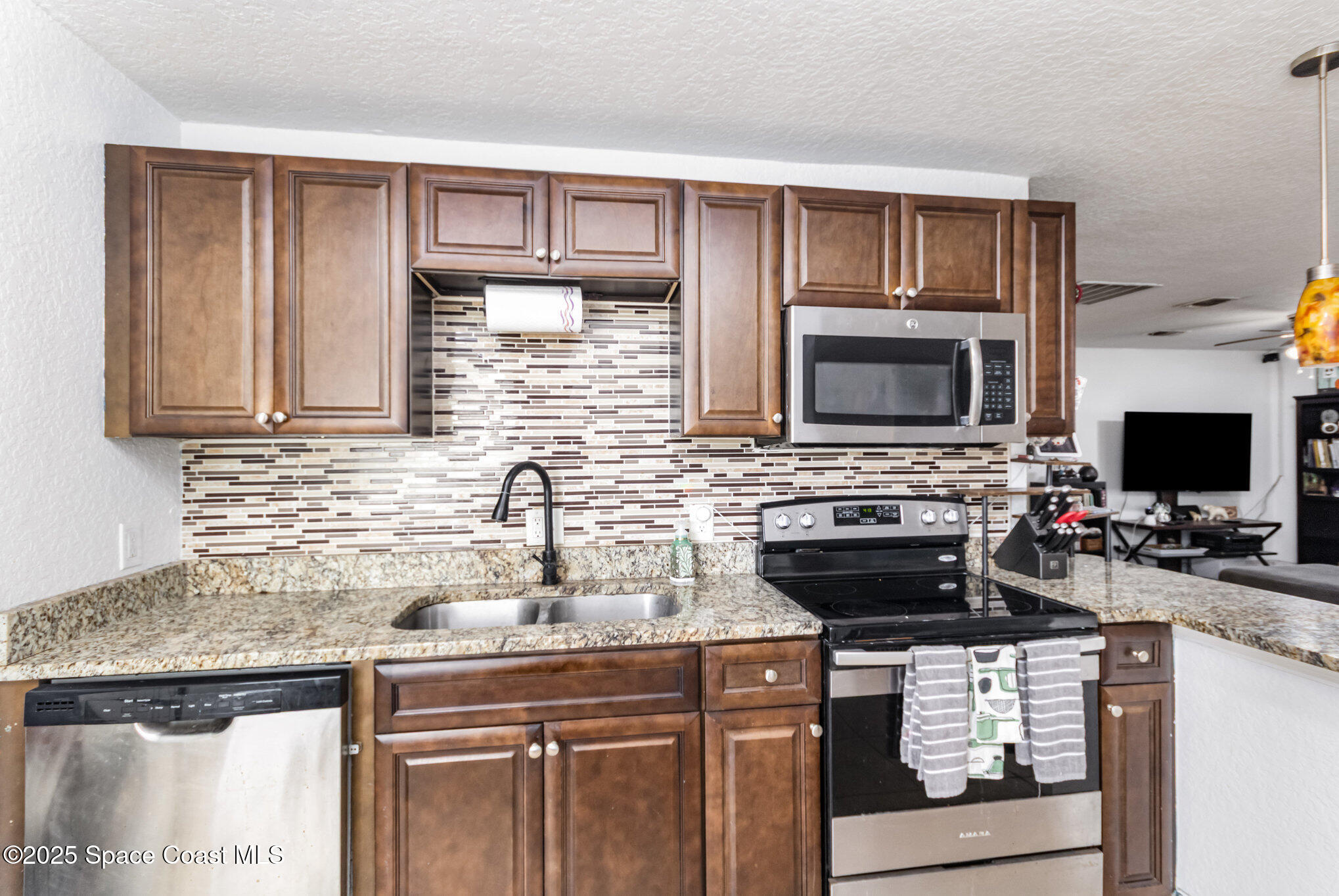 2004 High Street Leesburg, FL 34748 - Photo 13 of 30 a kitchen with a stove and a microwave