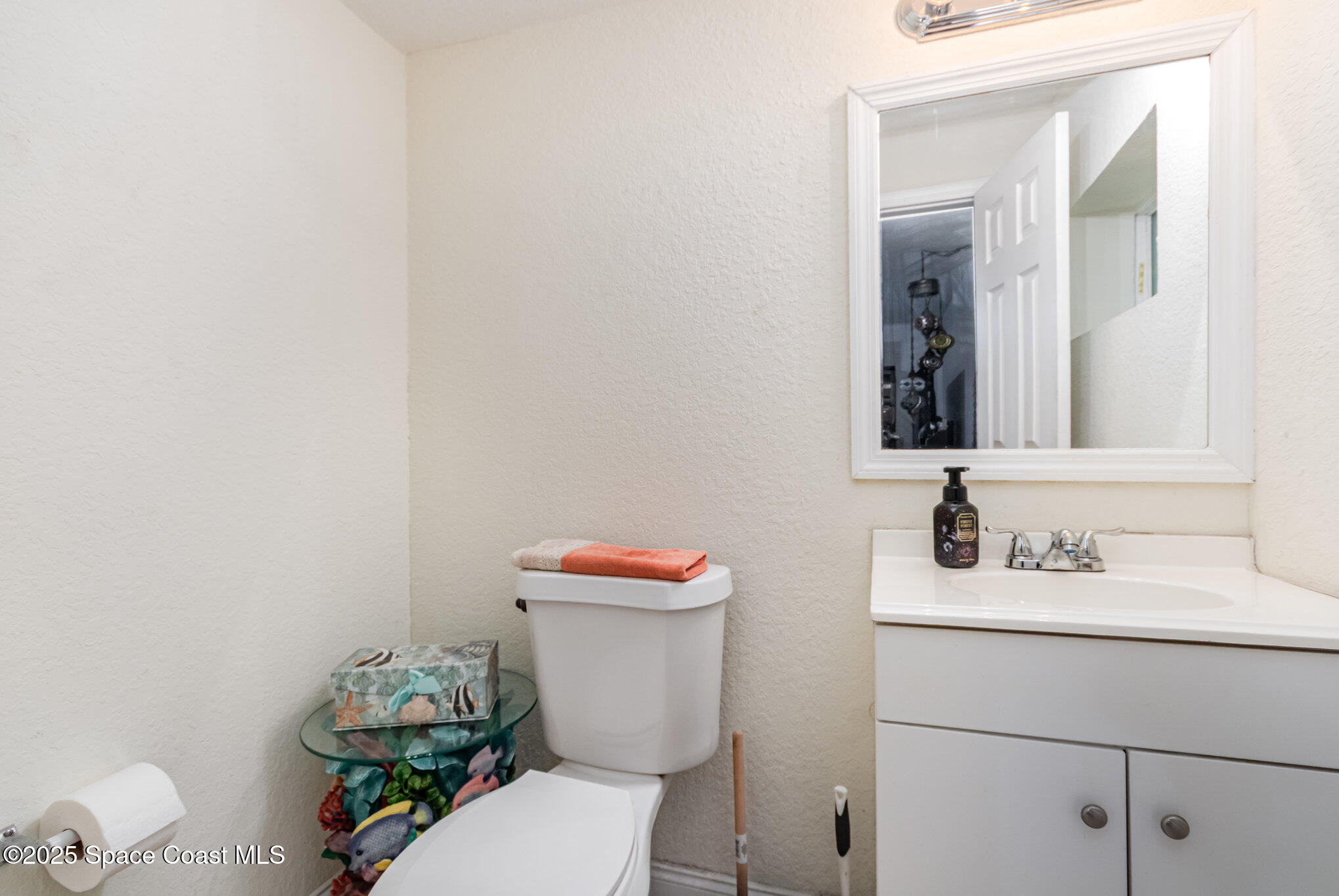 2004 High Street Leesburg, FL 34748 - Photo 14 of 30 a bathroom with a sink a toilet and a mirror