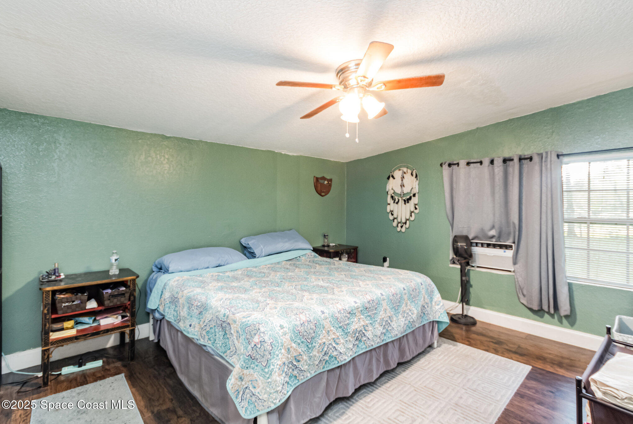 2004 High Street Leesburg, FL 34748 - Photo 15 of 30 a bedroom with a bed and a chandelier