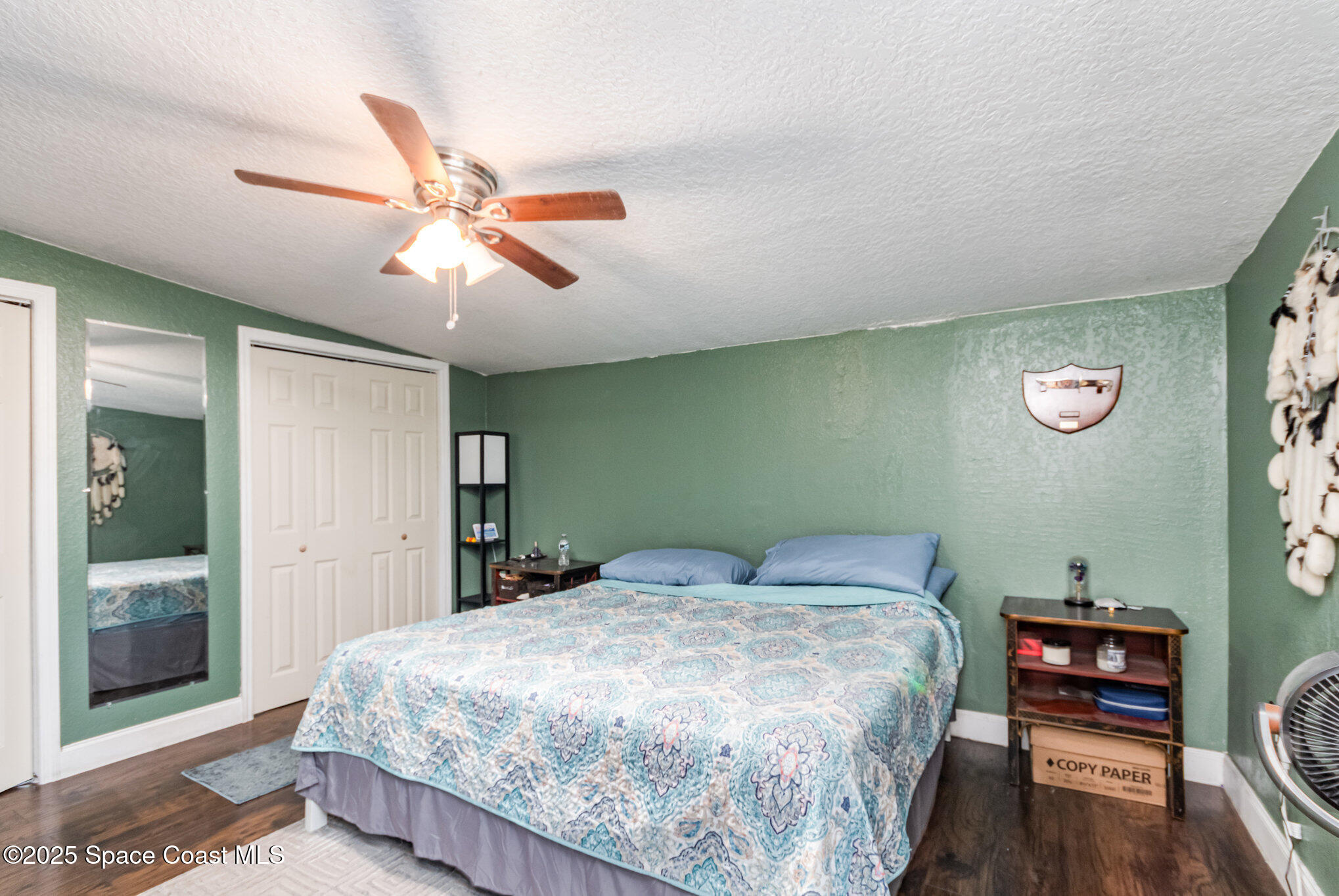 2004 High Street Leesburg, FL 34748 - Photo 17 of 30 a bedroom with a bed bookshelf and a chandelier
