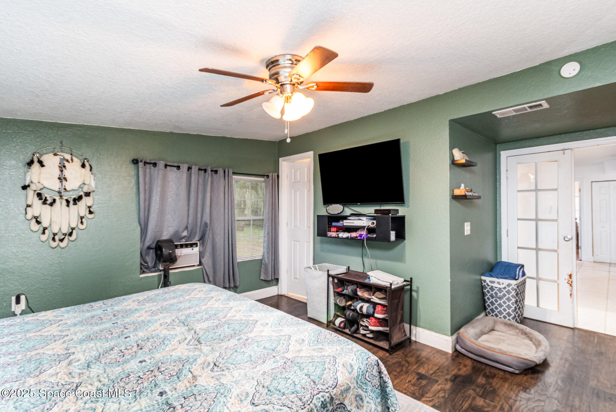 2004 High Street Leesburg, FL 34748 - Photo 18 of 30 a bedroom with a bed and a flat screen tv