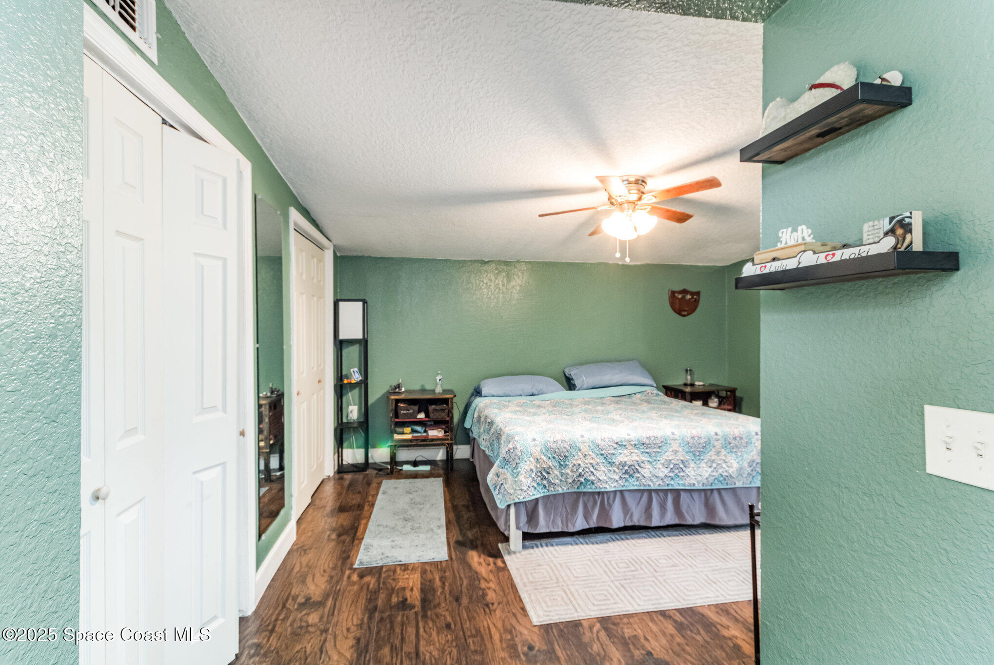 2004 High Street Leesburg, FL 34748 - Photo 19 of 30 a bedroom with a bed and a chandelier