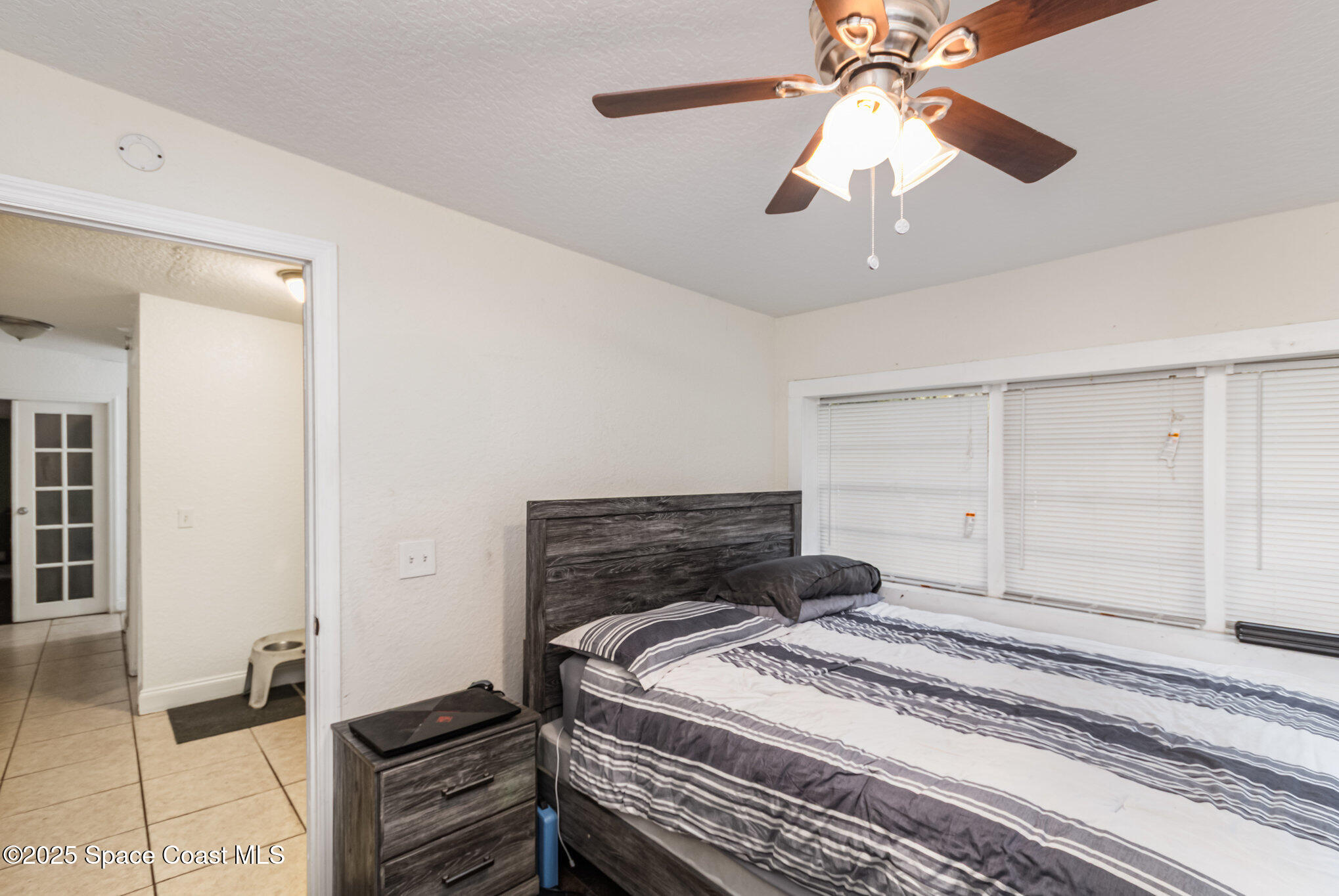 2004 High Street Leesburg, FL 34748 - Photo 23 of 30 a bedroom with a bed and a chandelier