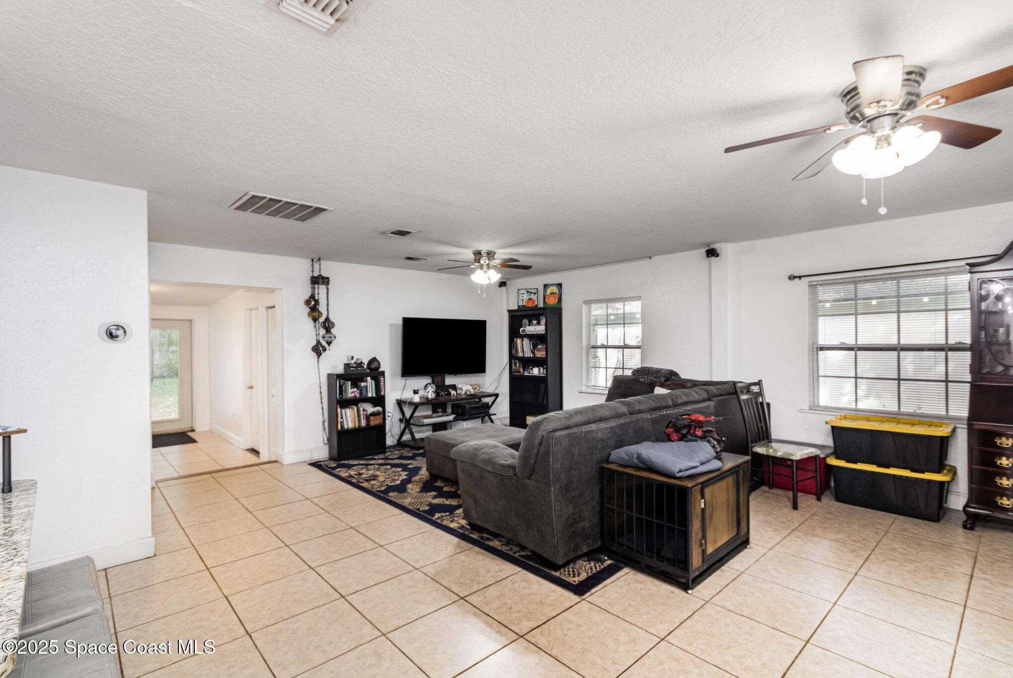 2004 High Street Leesburg, FL 34748 - Photo 6 of 30 a living room with furniture and a flat screen tv