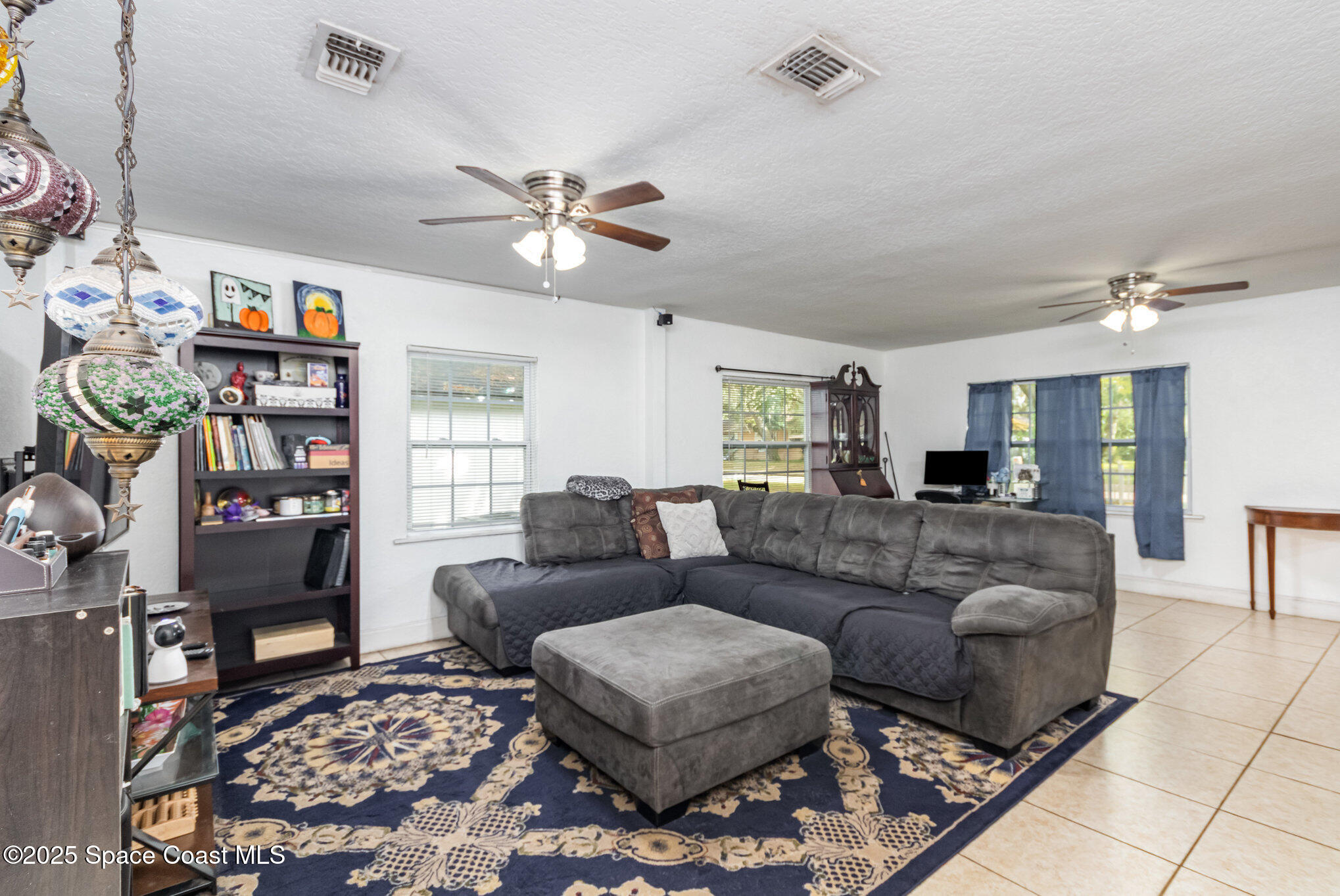 2004 High Street Leesburg, FL 34748 - Photo 8 of 30 a living room with furniture a rug and a window
