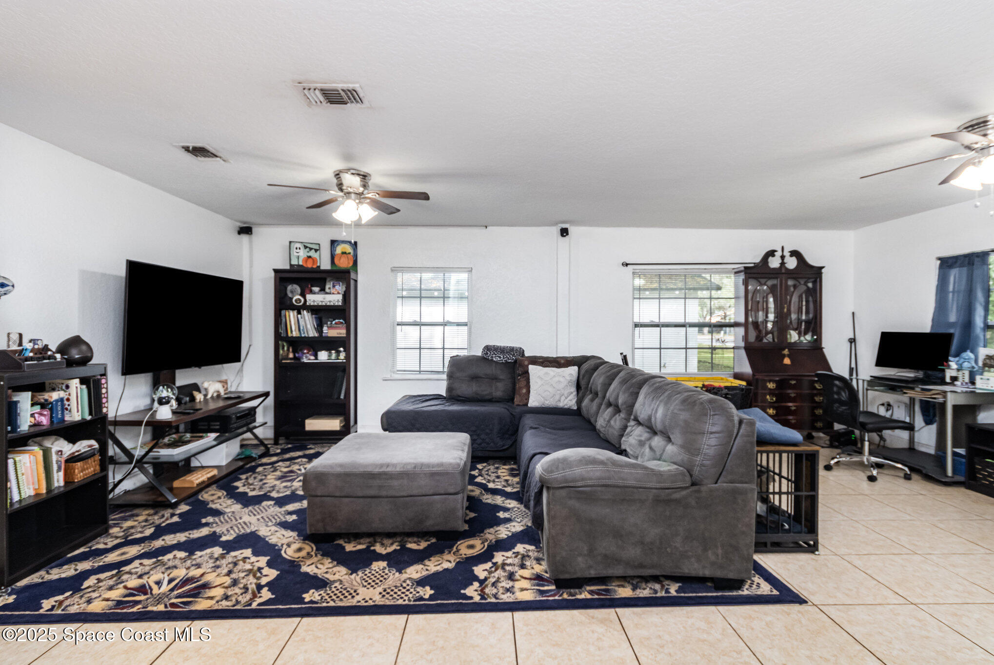 2004 High Street Leesburg, FL 34748 - Photo 9 of 30 a living room with furniture and a flat screen tv