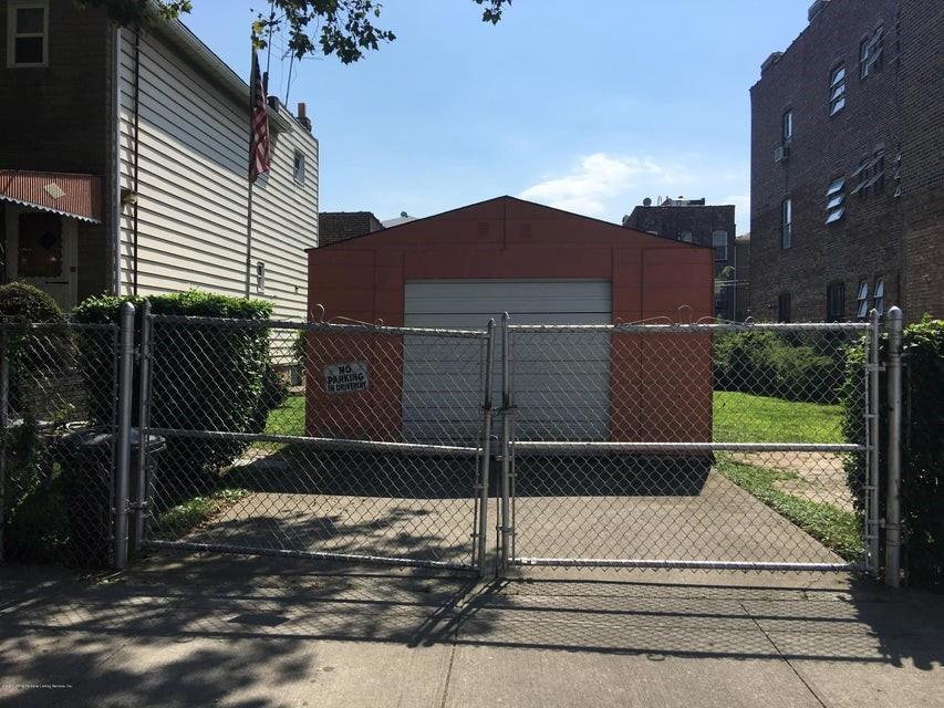 1472 67th Street Brooklyn, NY 11219 - Photo 5 of 5 a view of a street with brick wall and buildings