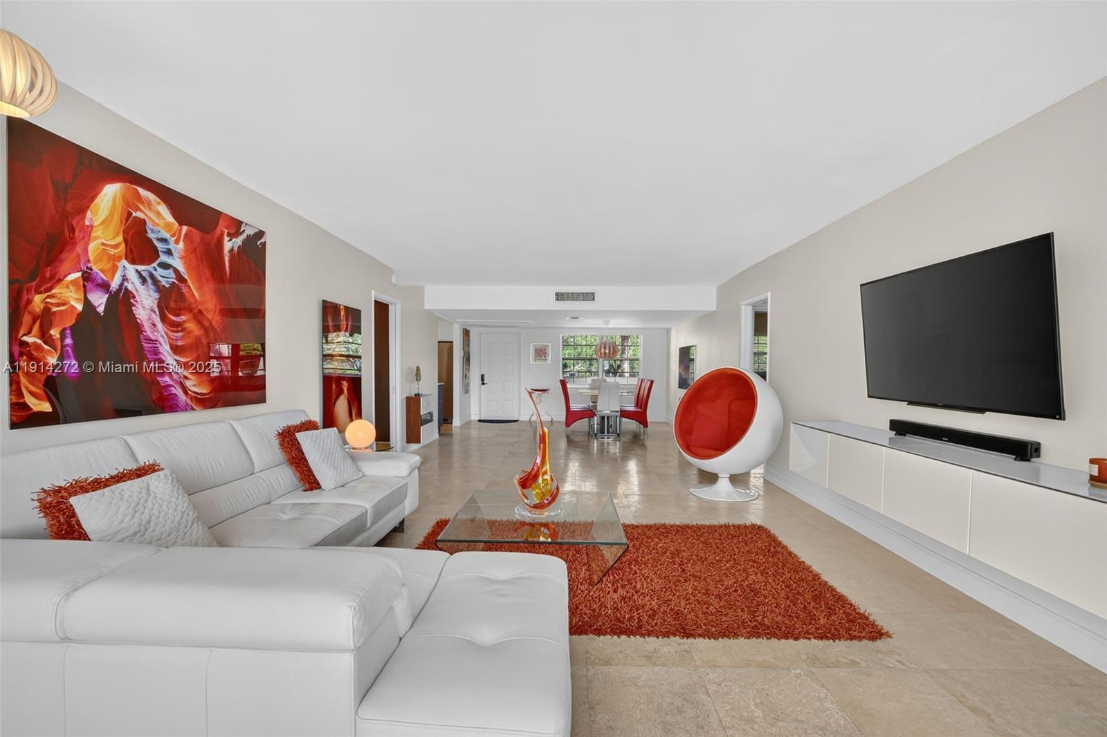 a living room with furniture and a flat screen tv
