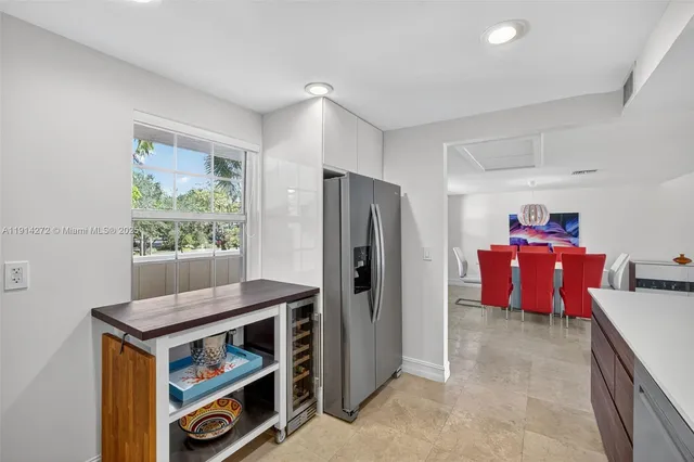 a kitchen with refrigerator and cabinets