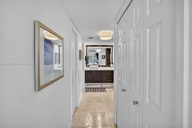 a view of a hallway view with wooden floor and living room