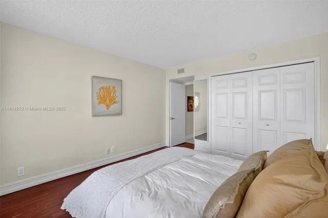 a bedroom with a bed and a painting