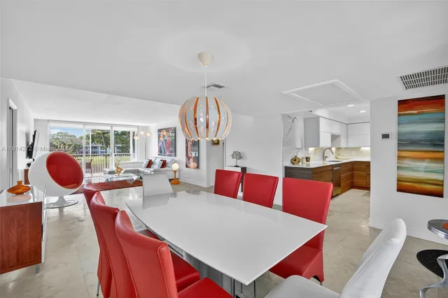 a living room with furniture a rug and a large window