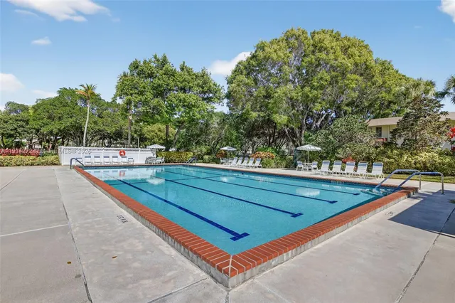 a front view of a house with garden and patio