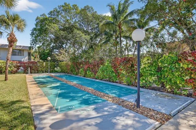 a dining room with furniture a rug and a large window