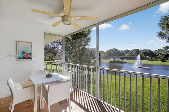 a balcony with wooden floor and outdoor seating