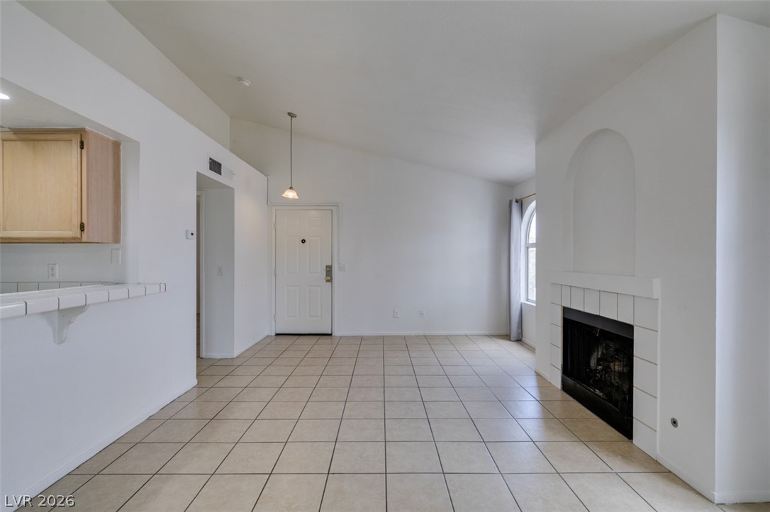7570 West Flamingo Road, Unit 252 Las Vegas, NV 89147 - Photo 9 of 44 A fireplace feature graces this inviting room, perfect for cozy gatherings and elegant living.
