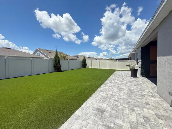 a front view of a house with a garden and yard