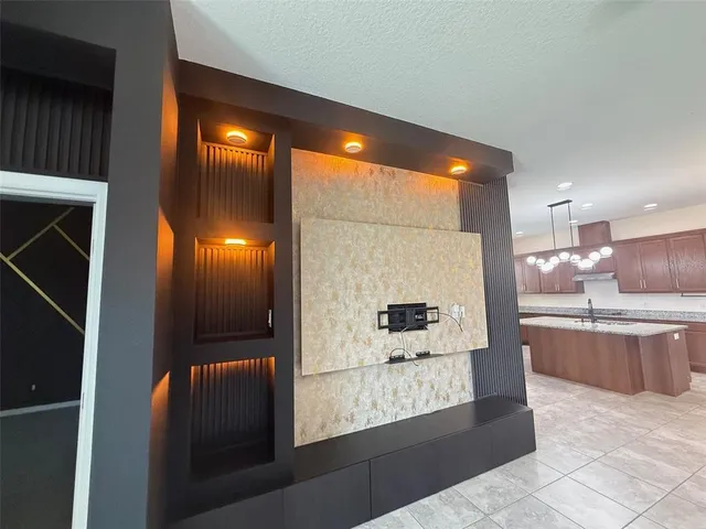 a kitchen with stainless steel appliances kitchen island granite countertop a refrigerator and a stove