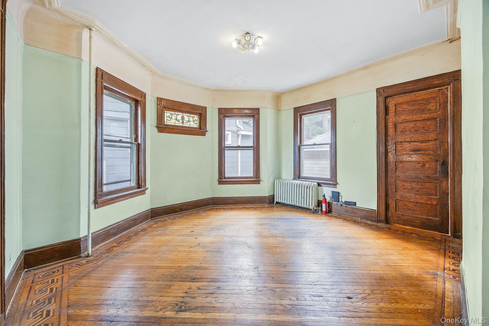 770 Argyle Road Brooklyn, NY 11230 - Photo 12 of 28 a view of an empty room with window and wooden floor