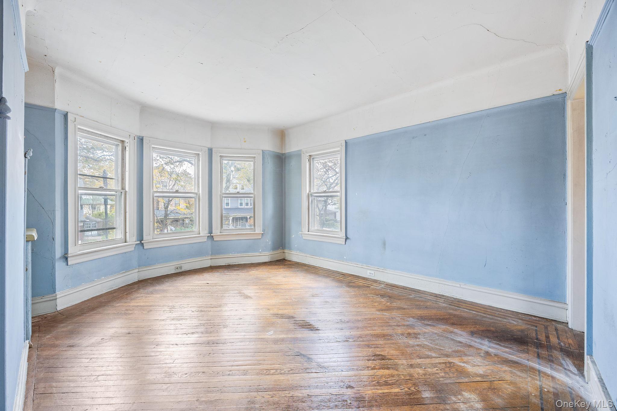 770 Argyle Road Brooklyn, NY 11230 - Photo 14 of 28 a view of empty room with wooden floor and fan