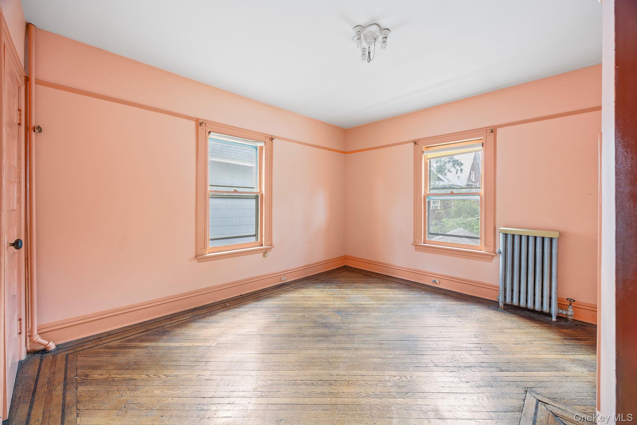 770 Argyle Road Brooklyn, NY 11230 - Photo 17 of 28 an empty room with wooden floor and windows