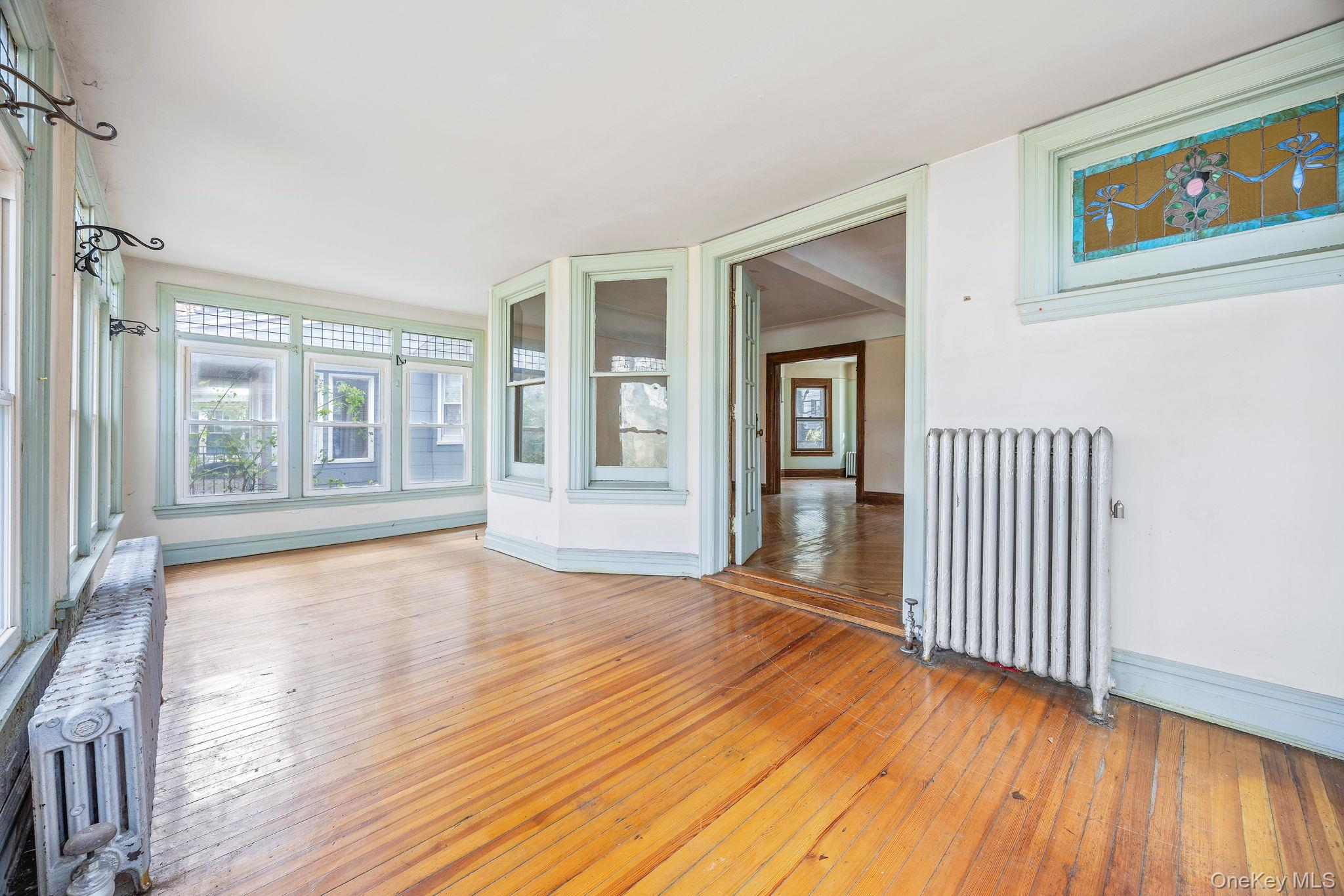 770 Argyle Road Brooklyn, NY 11230 - Photo 5 of 28 a view of an empty room with wooden floor and a window