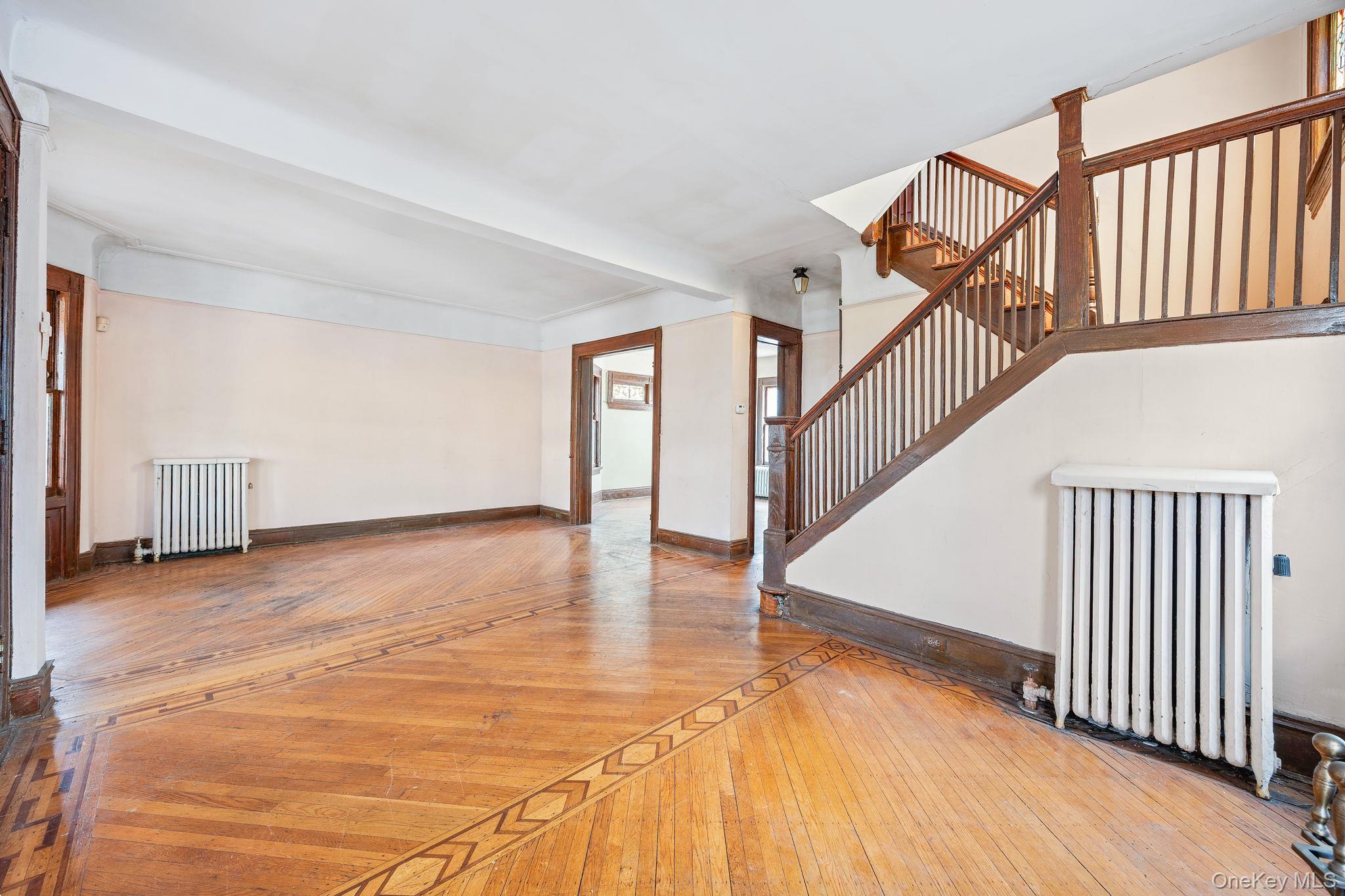 770 Argyle Road Brooklyn, NY 11230 - Photo 7 of 28 a view of an empty room with wooden floor and stairs